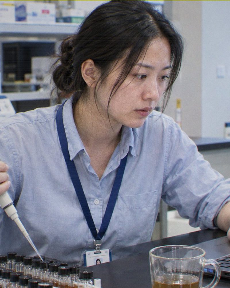 Zhou Min, Technical Service Lead at Sensilchem, running a laboratory trial with sample vials