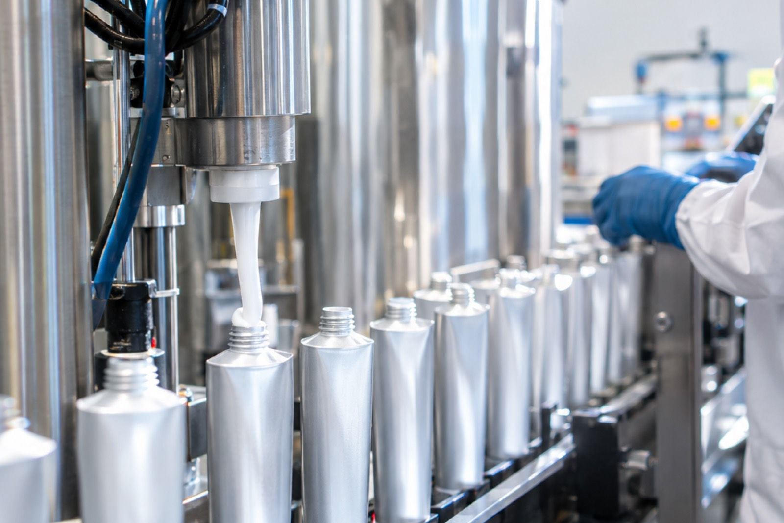 Toothpaste filling machine dispensing paste into aluminium laminate tubes